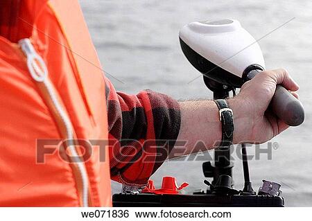 Stock Photograph - Man steering a boat with electric outboard-motor (trolling-motor) over Gaviksfj? rden, Norastr÷m, V? sternorrlands l? n, Sweden, Scandinavia, Europe. Fotosearch