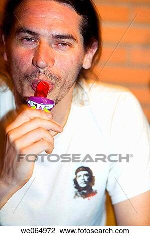 Man sucking candie View Large Photo Image Stock Image - Man sucking candie. Fotosearch