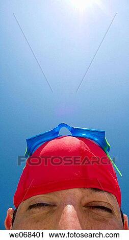 Man wearing swimming goggles and cap. View Large Photo Image Stock Image - Man wearing swimming goggles and cap.. Fotosearch