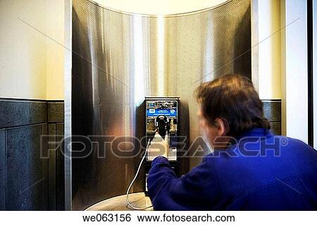 Stock Photograph - Man's hand on a pay telephone. Fotosearch