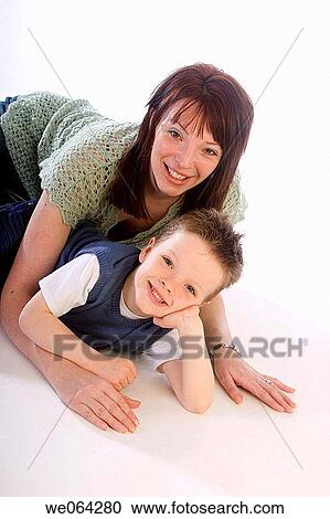 mother and 4 year old son lying together on the studio floor, smiling into camera View Large Photo Image Stock Image - mother and 4 year old son lying together on the studio floor, smiling into camera. Fotosearch