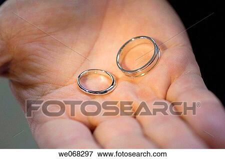 Pair of wedding rings on palm View Large Photo Image Stock Photo - Pair of wedding rings on palm. Fotosearch