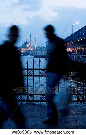 People crossing Galata bridge and Yeni mosque in background in the evening, Istanbul. Turkey View Large Photo Image Stock Photography - People crossing Galata bridge and Yeni mosque in background in the evening, Istanbul. Turkey. Fotosearch