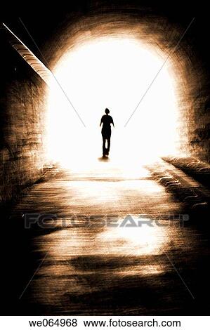 Stock Photo - Person coming out from an old tunnel. Fotosearch