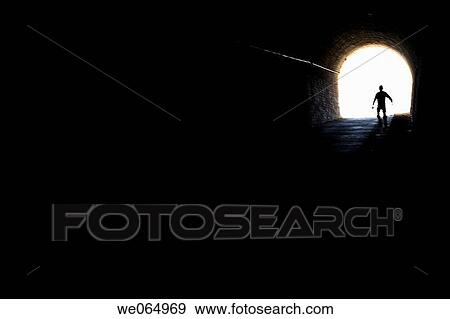 Person coming out from an old tunnel View Large Photo Image Stock Photo - Person coming out from an old tunnel. Fotosearch