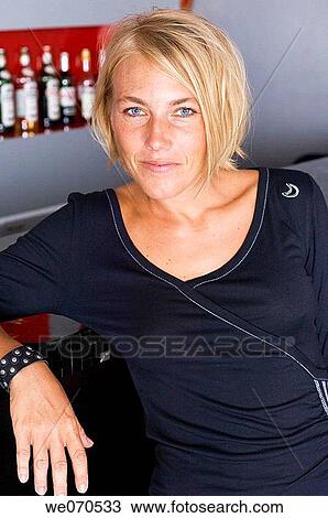 Portrait of woman posing by bar counter View Large Photo Image Stock Image - Portrait of woman posing by bar counter. Fotosearch