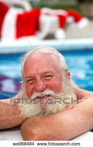 Santa smiles on the side of a swimming pool View Large Photo Image Picture - Santa smiles on the side of a swimming pool. Fotosearch