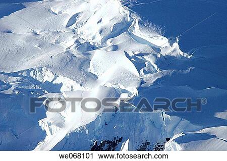 Snow capped mountains with snow cornices near the Antarctic Peninsula. View Large Photo Image Stock Image - Snow capped mountains with snow cornices near the Antarctic Peninsula.. Fotosearch