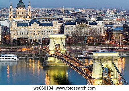 Szechenyi Chain Bridge over the Danube lit up at night viewed from Castle Hill with St Stephen Basilica in the background. Budapest. Hungary View Large Photo Image Picture - Szechenyi Chain Bridge over the Danube lit up at night viewed from Castle Hill with St Stephen Basilica in the background. Budapest. Hungary. Fotosearch