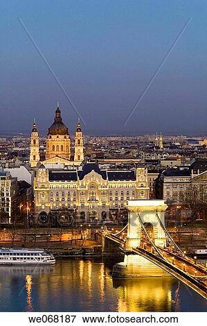 Szechenyi Chain Bridge over the Danube lit up at night viewed from Castle Hill with St Stephen Basilica in the background. Budapest. Hungary View Large Photo Image Stock Photo - Szechenyi Chain Bridge over the Danube lit up at night viewed from Castle Hill with St Stephen Basilica in the background. Budapest. Hungary. Fotosearch