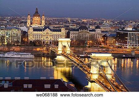 Szechenyi Chain Bridge over the Danube lit up at night viewed from Castle Hill with St Stephen Basilica in the background. Budapest. Hungary View Large Photo Image Stock Photo - Szechenyi Chain Bridge over the Danube lit up at night viewed from Castle Hill with St Stephen Basilica in the background. Budapest. Hungary. Fotosearch