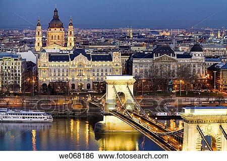 Szechenyi Chain Bridge over the Danube lit up at night viewed from Castle Hill with St Stephen Basilica in the background. Budapest. Hungary View Large Photo Image Stock Photograph - Szechenyi Chain Bridge over the Danube lit up at night viewed from Castle Hill with St Stephen Basilica in the background. Budapest. Hungary. Fotosearch