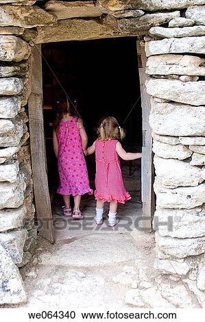 the back of 2 sisters age 3 aAND 5, looking through a dark doorway View Large Photo Image Stock Image - the back of 2 sisters age 3 aAND 5, looking through a dark doorway. Fotosearch