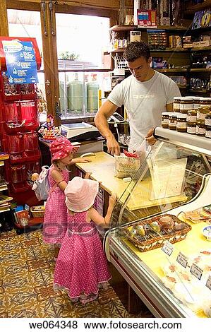 the back of 2 sisters age 3 aAND 5, standing at a shop counter buying some food View Large Photo Image Stock Photo - the back of 2 sisters age 3 aAND 5, standing at a shop counter buying some food. Fotosearch