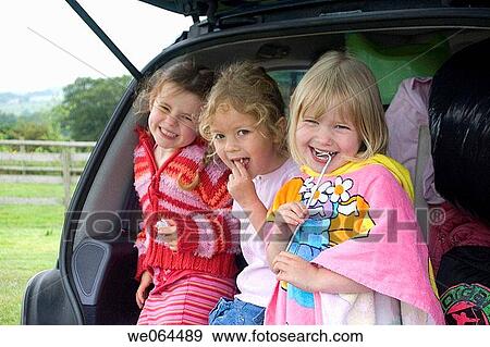 three 4 year old girls standing in the back of the car smiing into camera View Large Photo Image Stock Photo - three 4 year old girls standing in the back of the car smiing into camera. Fotosearch