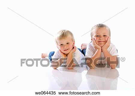 two brothers aged 5 and 3 lying together on the floor of the studio, head in hands View Large Photo Image Stock Photography - two brothers aged 5 and 3 lying together on the floor of the studio, head in hands. Fotosearch