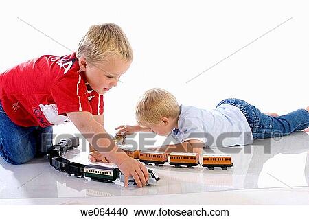 two brothers aged 5 and 3 playing trains together on the floor View Large Photo Image Stock Image - two brothers aged 5 and 3 playing trains together on the floor. Fotosearch