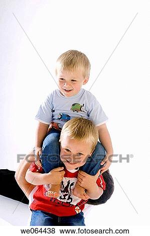 two brothers aged 5 and 3 playing together on the floor View Large Photo Image Stock Photo - two brothers aged 5 and 3 playing together on the floor. Fotosearch