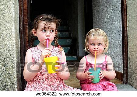 two sisters age 3 and 5 sitting on a step drinking through straws View Large Photo Image Stock Image - two sisters age 3 and 5 sitting on a step drinking through straws. Fotosearch