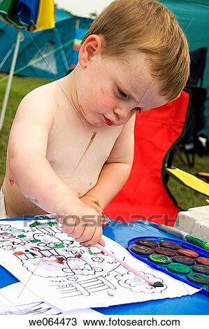 two year old boy standing up at a table outside painting View Large Photo Image Stock Image - two year old boy standing up at a table outside painting. Fotosearch