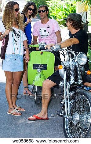 Two young couples on motorbikes View Large Photo Image Stock Photo - Two young couples on motorbikes. Fotosearch