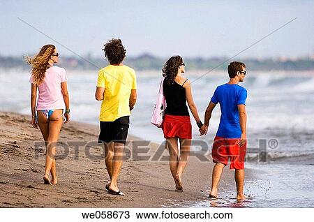 Two young couples on the beach View Large Photo Image Stock Image - Two young couples on the beach. Fotosearch