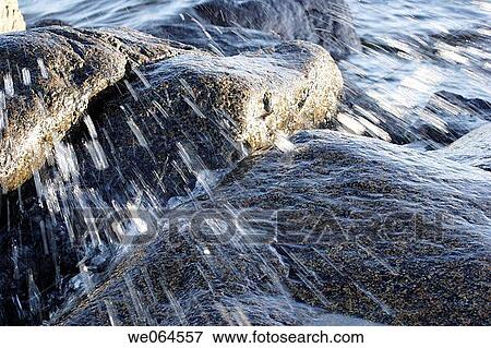 Wave spraying over stones. H÷ga Kusten, coast of Baltic Sea, V? sternorrlands l? n, Sweden, Scandinavia, Europe View Large Photo Image Stock Photo - Wave spraying over stones. H÷ga Kusten, coast of Baltic Sea, V? sternorrlands l? n, Sweden, Scandinavia, Europe. Fotosearch
