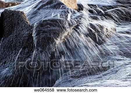 Wave spraying over stones. H÷ga Kusten, coast of Baltic Sea, V? sternorrlands l? n, Sweden, Scandinavia, Europe View Large Photo Image Stock Photo - Wave spraying over stones. H÷ga Kusten, coast of Baltic Sea, V? sternorrlands l? n, Sweden, Scandinavia, Europe. Fotosearch