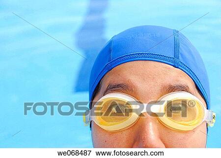 Woman wearing goggles and swimmer's cap. View Large Photo Image Stock Photo - Woman wearing goggles and swimmer's cap.. Fotosearch
