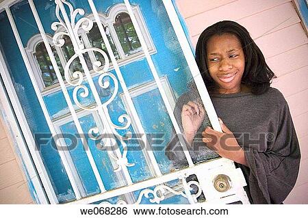 Young black woman posing in front of her house View Large Photo Image Stock Photograph - Young black woman posing in front of her house. Fotosearch