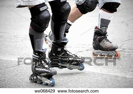Stock Photo - Young couple in-line skating. Fotosearch