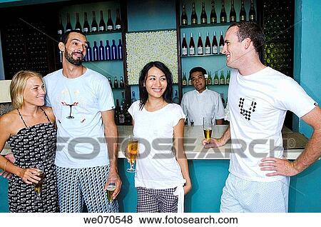 Stock Photo - Young couples drinking and talking. Fotosearch