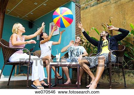 Young couples relaxing and playing View Large Photo Image Stock Photograph - Young couples relaxing and playing. Fotosearch