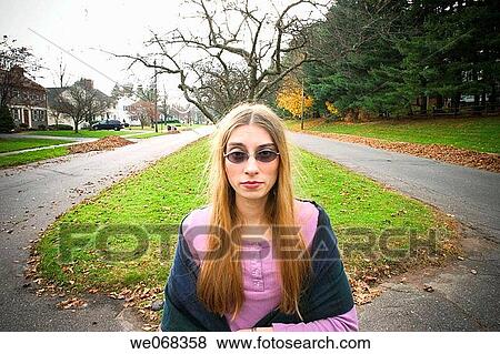 Young woman, wearing sunglasses, posing View Large Photo Image Stock Photo - Young woman, wearing sunglasses, posing. Fotosearch