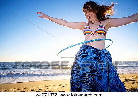 20 year old woman does the hula hoop on the Pacific ocean beach in Los Angeles, California, USA View Large Photo Image Stock Image - 20 year old woman does the hula hoop on the Pacific ocean beach in Los Angeles, California, USA. Fotosearch