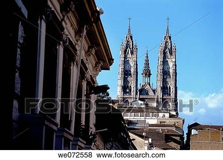 Stock Photo - 20th century Church of the Basilica rising over colonial buildings of the Old Town of the Andean capital of Quito, Ecuador. Fotosearch