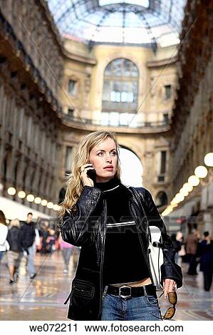 29 year old woman using cell phone in Galleria Vittorio Emanuelle II, Piazza del Duomo, Milan. Lombardy, Italy View Large Photo Image Stock Image - 29 year old woman using cell phone in Galleria Vittorio Emanuelle II, Piazza del Duomo, Milan. Lombardy, Italy. Fotosearch