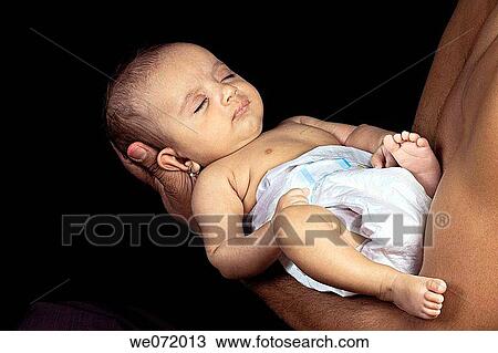 Stock Image - A newborn baby in the arms. Fotosearch