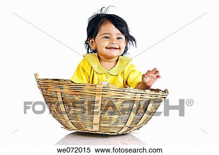 A smiling baby girl in a wooden basket View Large Photo Image Stock Photography - A smiling baby girl in a wooden basket. Fotosearch