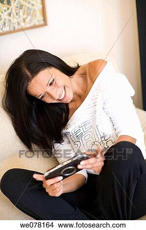amusement, brunette, at-home, addiction View Large Photo Image Picture - amusement, brunette, at-home, addiction. Fotosearch