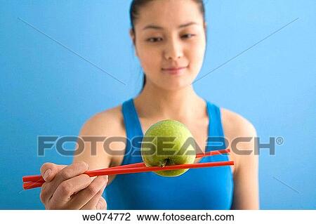 Stock Image - apple, chopstick, Asian, ability. Fotosearch