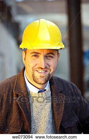 Architect, Engineer, General Contractor with hard hat on construction site View Large Photo Image Picture - Architect, Engineer, General Contractor with hard hat on construction site. Fotosearch