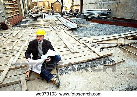 Architect, Engineer, General Contractor on ground in construction site reading plans View Large Photo Image Stock Image - Architect, Engineer, General Contractor on ground in construction site reading plans. Fotosearch
