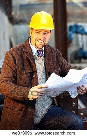 Architect, Engineer, General Contractor with hard hat on construction site reading plans View Large Photo Image Stock Photography - Architect, Engineer, General Contractor with hard hat on construction site reading plans. Fotosearch