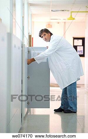 Stock Image - arrangement, black hair, armoire. Fotosearch