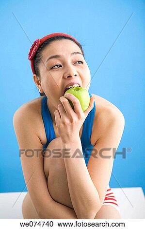 Asian, biting, bite, apple View Large Photo Image Stock Image - Asian, biting, bite, apple. Fotosearch