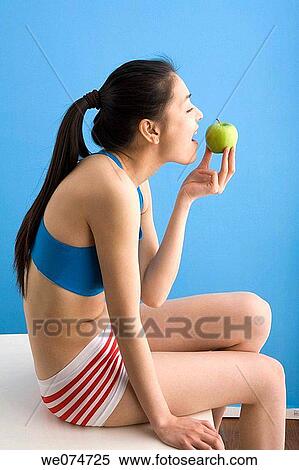 Asian, biting, bite, apple View Large Photo Image Stock Photography - Asian, biting, bite, apple. Fotosearch