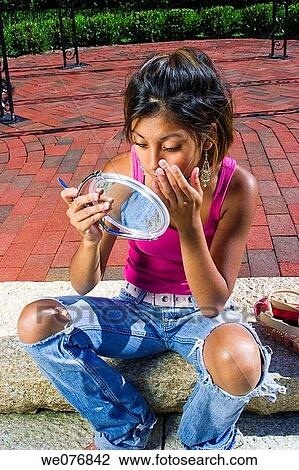 Asian/Hispanic teen girl adjusting her makeup. View Large Photo Image Stock Image - Asian/Hispanic teen girl adjusting her makeup.. Fotosearch