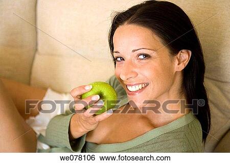 Stock Photograph - at-home, brunette, apple. Fotosearch