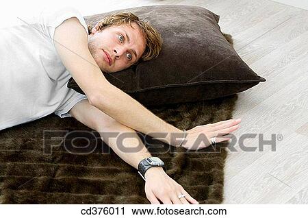 Stock Image - at-home, carpet, absorbed. Fotosearch